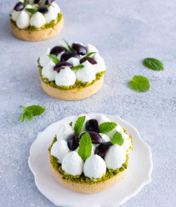 three cherry pistachio tart on table