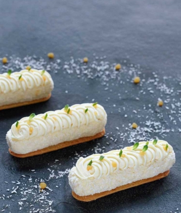 Three mango cheesecakes on grey stone platter