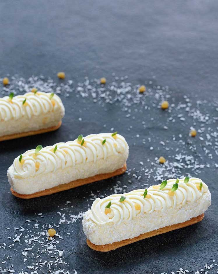 Three mango cheesecakes on grey stone platter