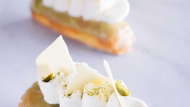 three matcha white eclairs on table