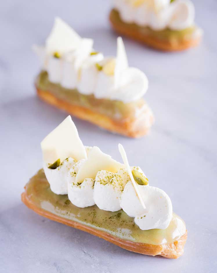 Three matcha white eclairs on table